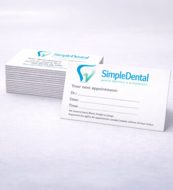 A stack of appointment cards for a dentist office named Simple Dental with a blue tooth logo.