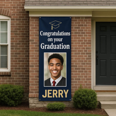 A blue Graduation Banner hanging outside a home. The banner contains the words congratulations on your graduation Jerry with a photo of the graduate.