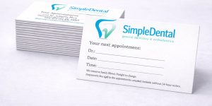A stack of appointment cards for a dentist office named Simple Dental with a blue tooth logo.